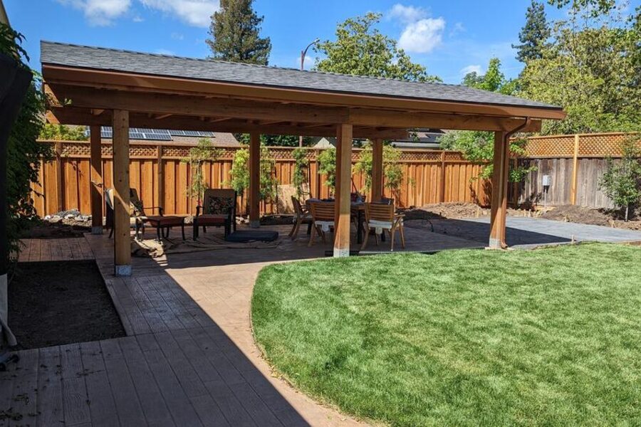 Backyard stamped concrete patio with covered pergola