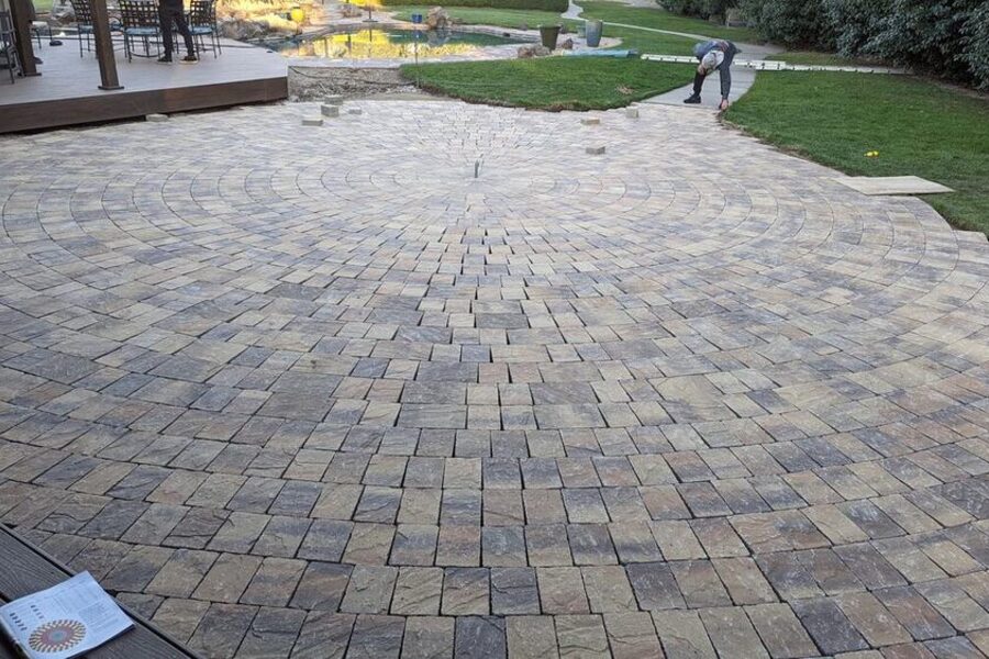 Circular paver patio installation in a backyard