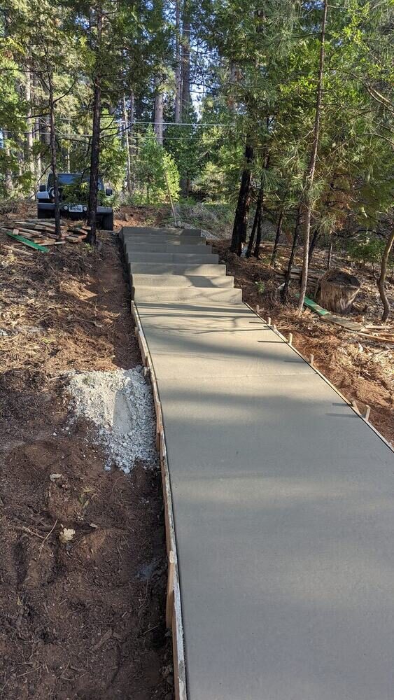 Custom concrete steps and walkway on a wooded hillside