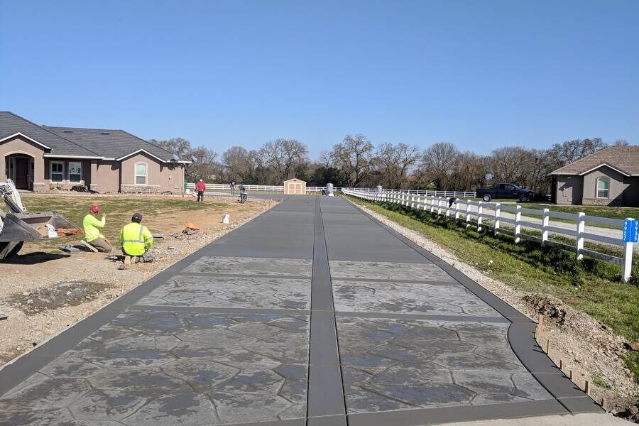 Long concrete driveway with custom stamped borders