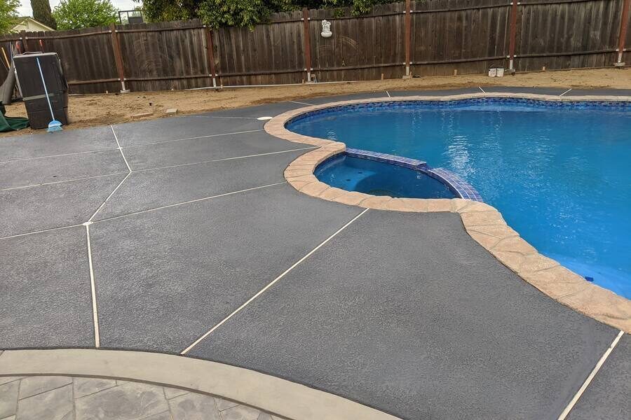 Pool deck resurfaced with a decorative concrete overlay
